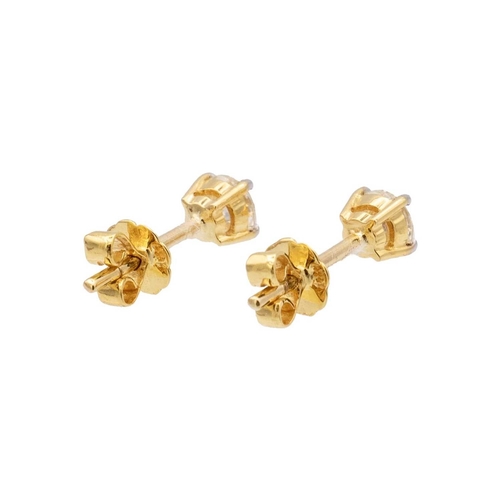 122 - A pair of 18k yellow gold diamond stud earrings. The clean white round brilliant-cut diamonds are 0.... 