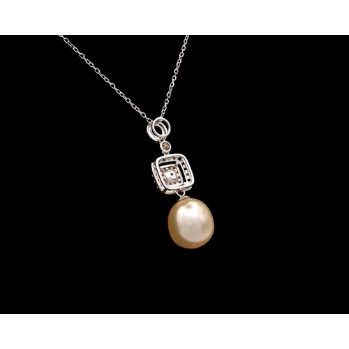 126 - An 18k gold pendant set with cultured golden pearl with yellow and white diamonds on a chain. The pe... 