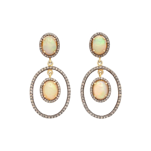 135 - A pair of silver gilt opal and diamond set pendant earrings. An opal cabochons are 9mm x 7mm each ap... 