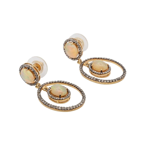 135 - A pair of silver gilt opal and diamond set pendant earrings. An opal cabochons are 9mm x 7mm each ap... 