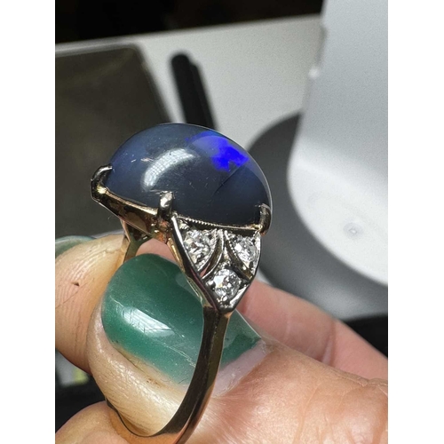 14 - A good Art Deco black opal and diamond set gold and platinum dress ring. The large cabochon opal wit... 