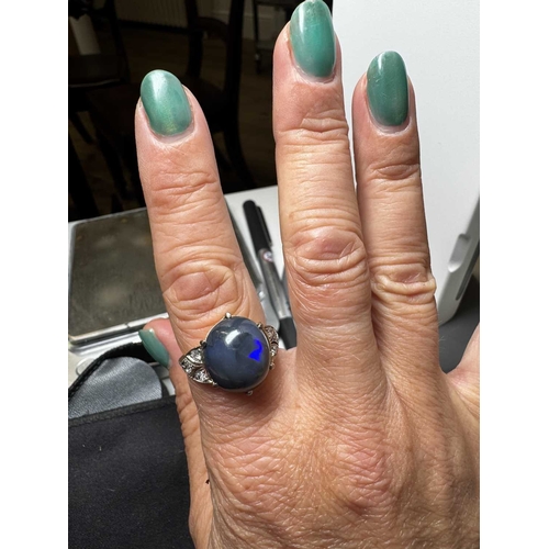 14 - A good Art Deco black opal and diamond set gold and platinum dress ring. The large cabochon opal wit... 