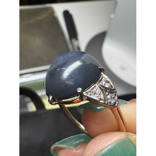 14 - A good Art Deco black opal and diamond set gold and platinum dress ring. The large cabochon opal wit... 