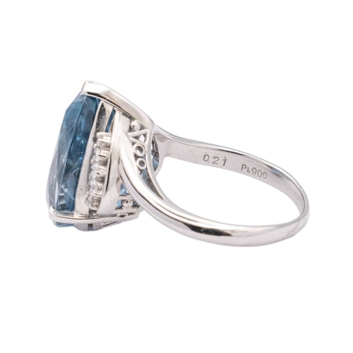 144 - A large Swiss blue topaz and diamond set dress ring in platinum. The pear-shaped mixed-cut topaz is ... 