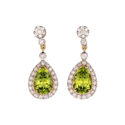 146 - A pair of 18k gold peridot and diamond set pendant earrings. The pear-shaped mixed-cut peridots are ... 