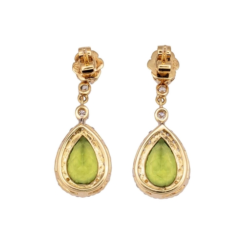 146 - A pair of 18k gold peridot and diamond set pendant earrings. The pear-shaped mixed-cut peridots are ... 