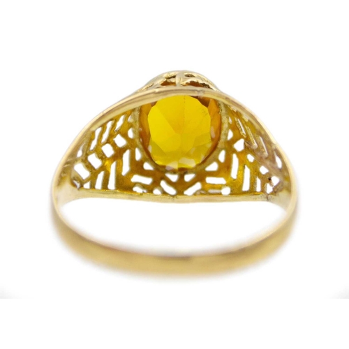 152 - An 18k gold synthetic yellow sapphire set ring. Stamped 750, the ring size Q, total weight 2.5g. Sli... 
