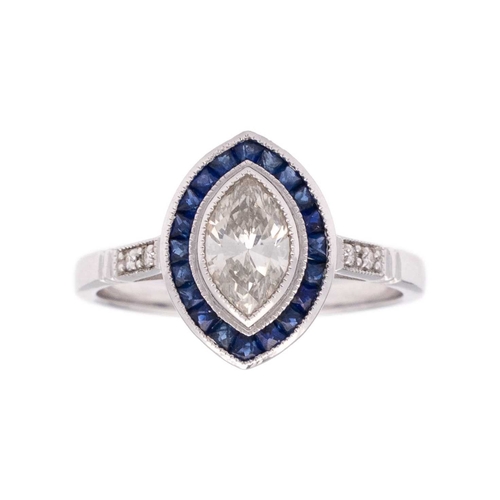 153 - An 18k white gold diamond and sapphire navette-shaped ring. Set with marquise-cut white diamond, sur... 