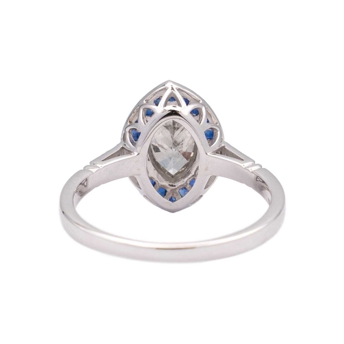 153 - An 18k white gold diamond and sapphire navette-shaped ring. Set with marquise-cut white diamond, sur... 