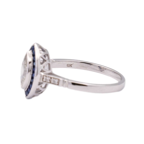 153 - An 18k white gold diamond and sapphire navette-shaped ring. Set with marquise-cut white diamond, sur... 