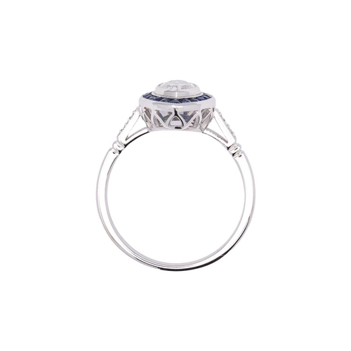 153 - An 18k white gold diamond and sapphire navette-shaped ring. Set with marquise-cut white diamond, sur... 