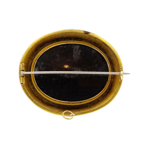 159 - A Victorian 14k gold (tested) Etruscan Revival oval locket brooch. The glazed panel front inset with... 