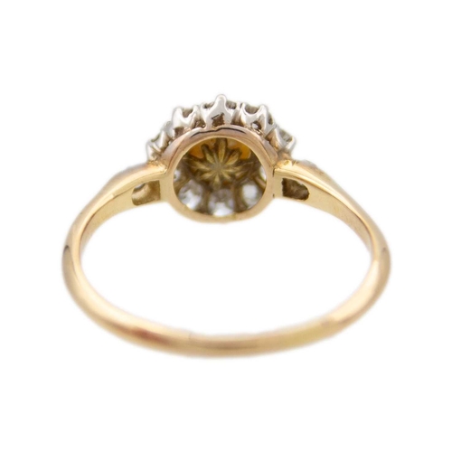 17 - A high purity gold pearl and diamond cluster ring. The cultured pearl is 5.6mm in diameter, surround... 