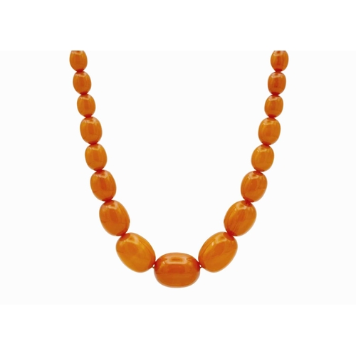 171 - A graduated butterscotch 'amber' style necklace. The oval beads are 8mm-23mm, forty-nine beads, scre... 