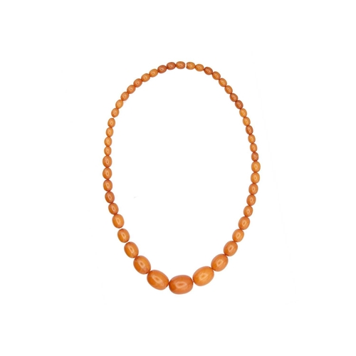 171 - A graduated butterscotch 'amber' style necklace. The oval beads are 8mm-23mm, forty-nine beads, scre... 