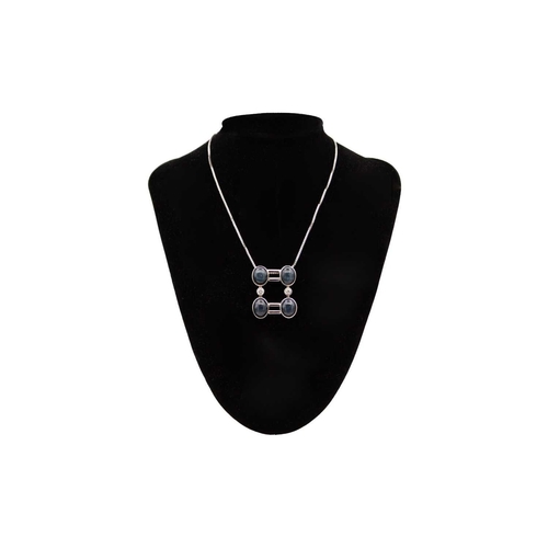 27 - An 18k white gold contemporary star-sapphire and diamond set pendant necklace. The heavy pendant set... 