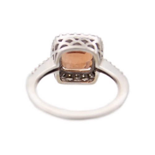 28 - A pinkish orange tourmaline and diamond set white gold ring. The square-shaped cushion-cut tourmalin... 