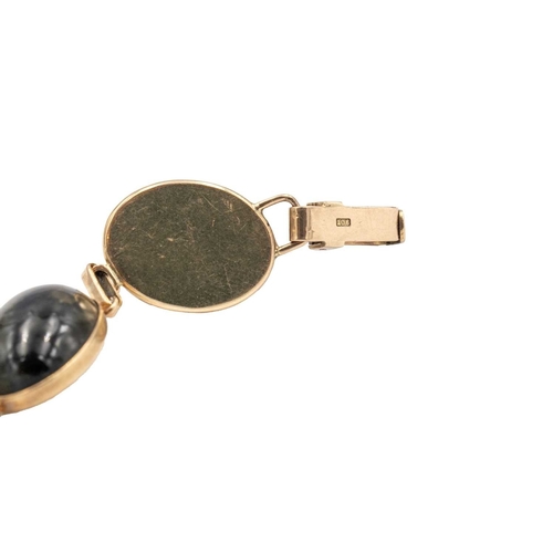 32 - A 9k rose gold bracelet set with various quartz gems. Each oval cabochon gem in a closed back settin... 