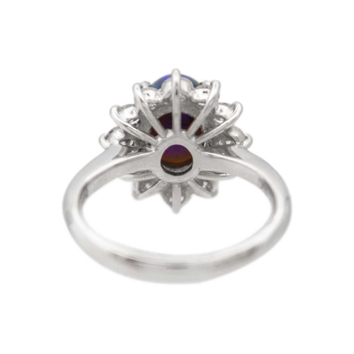 35 - A good black opal diamond ring, set in platinum. The oval-shaped cabochon opal is 9 x 7mm and depth ... 