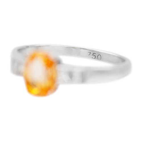 40 - A peach sapphire and diamond set 18k white gold ring. The elongated cushion-cut sapphire is 7mm x 5m... 