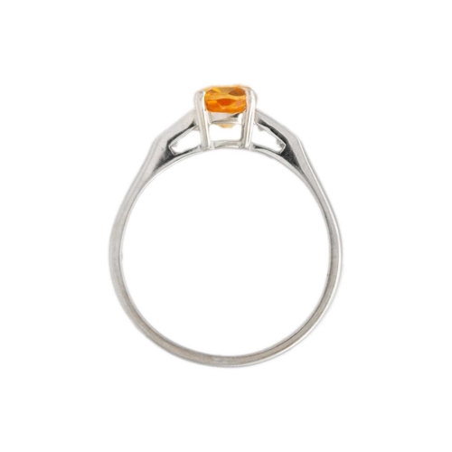 40 - A peach sapphire and diamond set 18k white gold ring. The elongated cushion-cut sapphire is 7mm x 5m... 