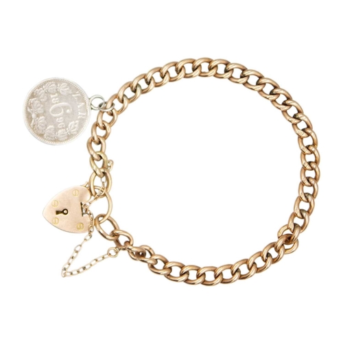 85 - A 9k rose gold curb link bracelet with a heart-shaped clasp. Fitted with a safety chain and a silver... 