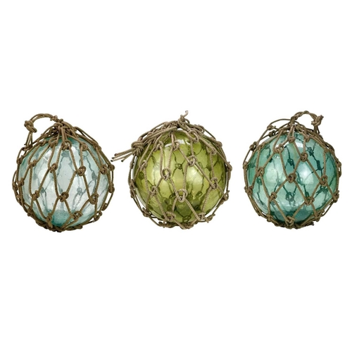 33 - Three large blown glass fishing floats. In varying green and blue tones, still with their original r... 
