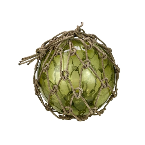 33 - Three large blown glass fishing floats. In varying green and blue tones, still with their original r... 