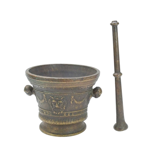 36 - A Renaissance style cast bronze mortar and pestle, dated 1630. With grotesque mask heads, swags, and... 