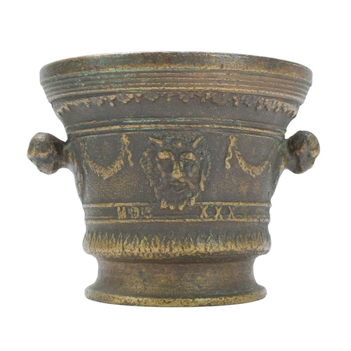 36 - A Renaissance style cast bronze mortar and pestle, dated 1630. With grotesque mask heads, swags, and... 