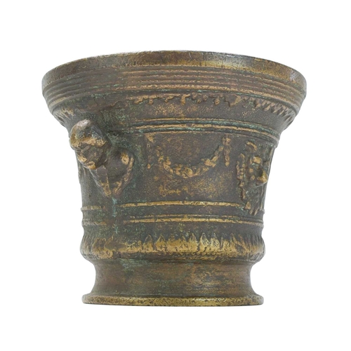 36 - A Renaissance style cast bronze mortar and pestle, dated 1630. With grotesque mask heads, swags, and... 