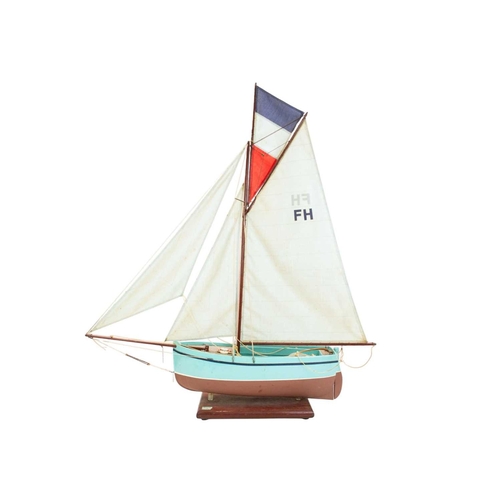 38 - A rigged model sailboat. By Cornish modeller John Pollard, on a wooden stand, height 96cm.