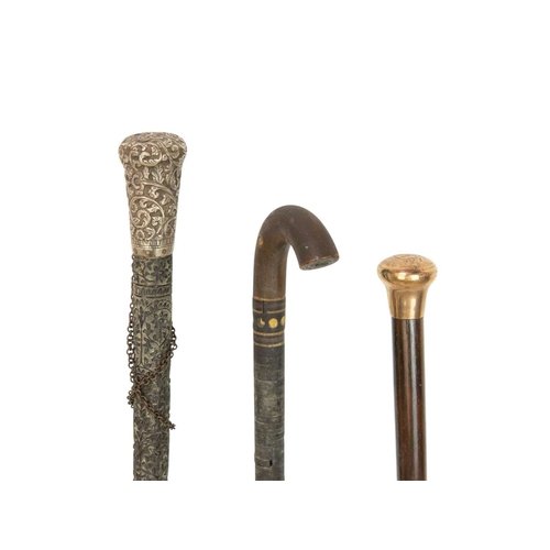 48 - Three walking canes. A 9ct gold mounted hardwood cane, a Sinhalese carved ebony cane with white meta... 