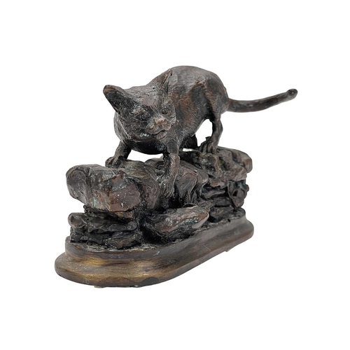 7 - After Jules Moigniez, a small bronze feline figure. 20th century, modelled on a rocky wall, height 9... 
