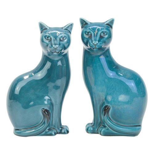 713 - A pair of mid century Poole pottery cats. Teal glaze, both stamped 'Poole England' to the base, heig... 