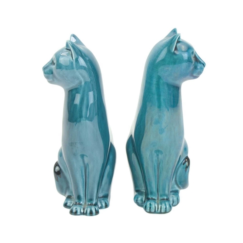 713 - A pair of mid century Poole pottery cats. Teal glaze, both stamped 'Poole England' to the base, heig... 