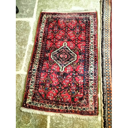 Two Persian Rugs A hand-knotted Persian rug, 290x130cm and a small rug ...