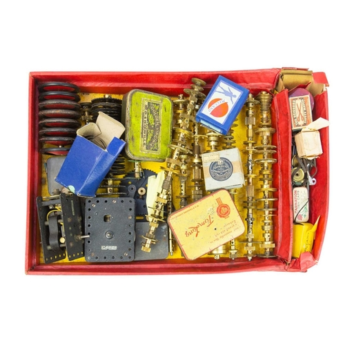 167 - A collection of Meccano in three trays. Including wheels, cylinders, motors, gears, instruction manu... 