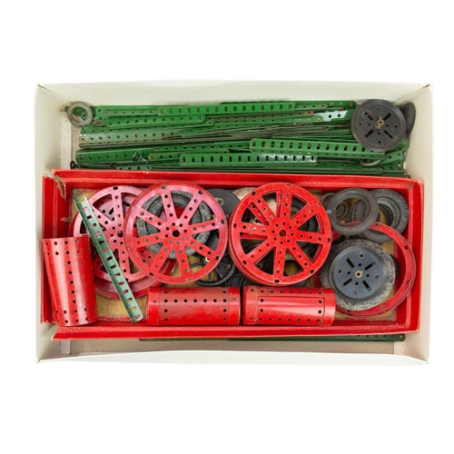 167 - A collection of Meccano in three trays. Including wheels, cylinders, motors, gears, instruction manu... 
