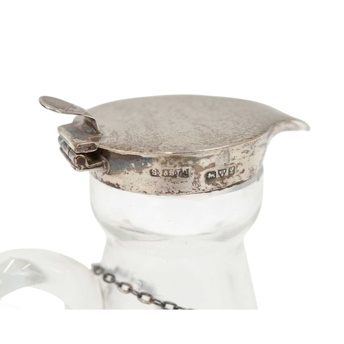 192 - Two silver mounted cut glass whisky noggins. The hinged covers marked for Chester, 1911, and London,... 