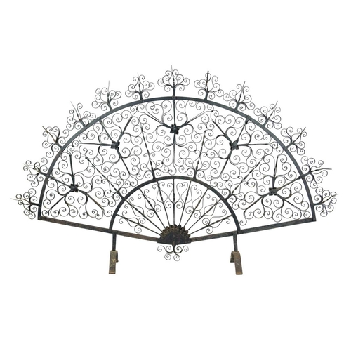 204 - An ornate wrought iron fire screen, attributed to Archibald Carne of Truro. Of ornate fan shape, hei... 