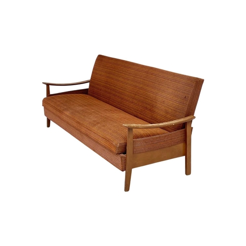 232 - A mid-century sofa bed. With stained beech framed arms and feet, height 79cm, width 193cm, depth 74c... 