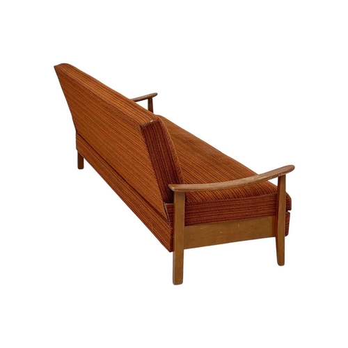 232 - A mid-century sofa bed. With stained beech framed arms and feet, height 79cm, width 193cm, depth 74c... 