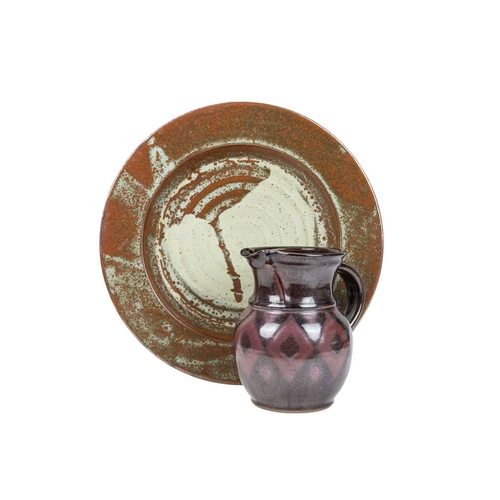 292 - A large studio pottery platter. Unmarked, diameter 40.5cm, together with a John Lomas iron glazed po... 