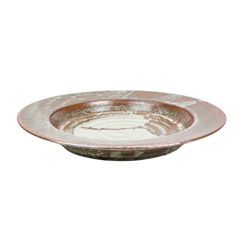 292 - A large studio pottery platter. Unmarked, diameter 40.5cm, together with a John Lomas iron glazed po... 