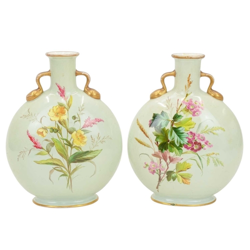 300 - A pair of porcelain moon flasks. Circa 1880, probably Minton, each with gilt handles and floral pain... 