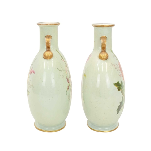 300 - A pair of porcelain moon flasks. Circa 1880, probably Minton, each with gilt handles and floral pain... 