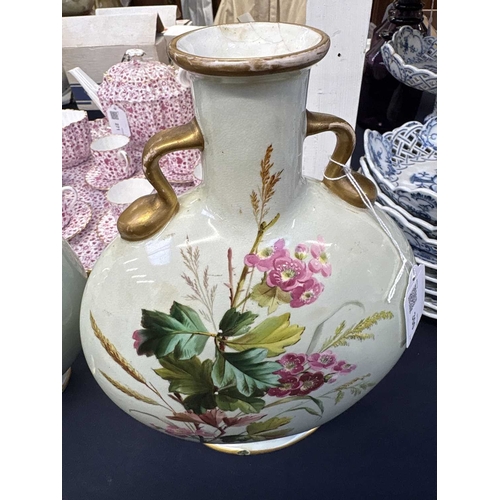 300 - A pair of porcelain moon flasks. Circa 1880, probably Minton, each with gilt handles and floral pain... 