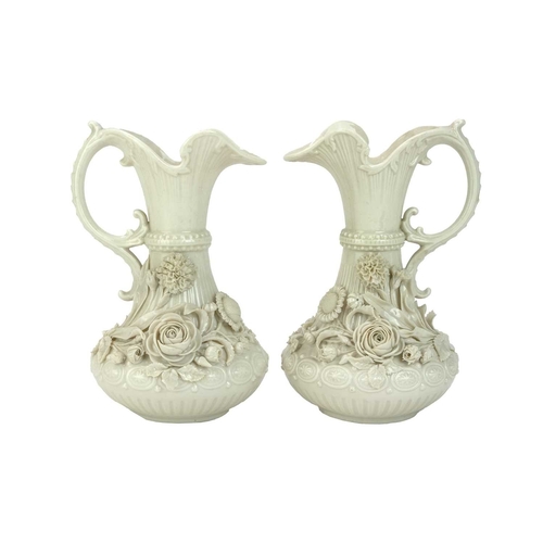 306 - A pair of Belleek 'Aberdeen' ewers. With floral encrusted decoration. Second period (1891-1926) fact... 