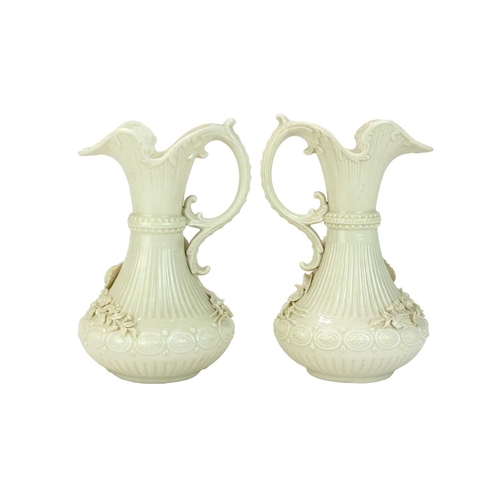 306 - A pair of Belleek 'Aberdeen' ewers. With floral encrusted decoration. Second period (1891-1926) fact... 